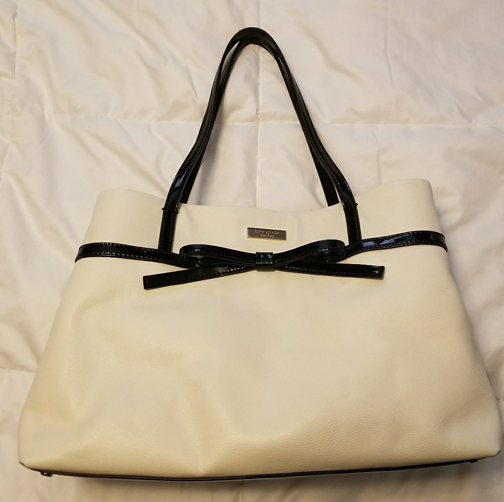 White Kate Spade bag with little black bow